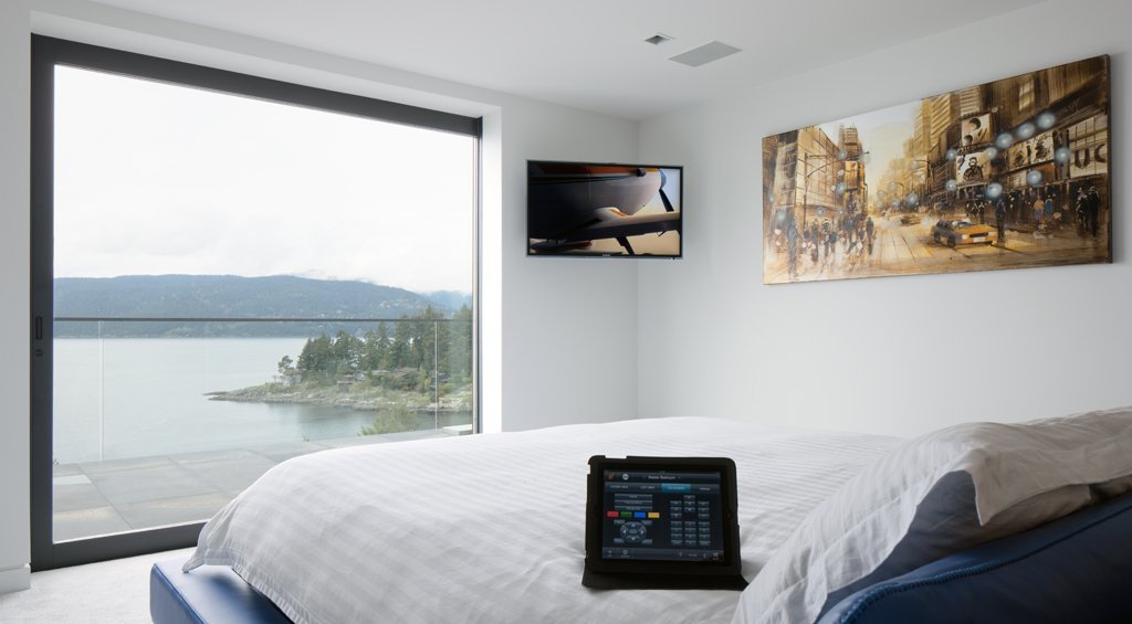 Bedroom with lake views and bedside controls